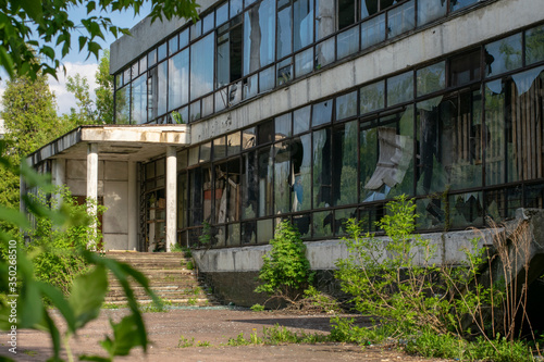 Facade of an abandoned building with broken windows