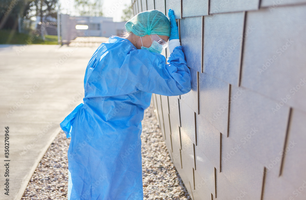 Doctor in protective clothing during coronavirus pandemic is overloaded