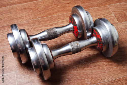 two dumbbells are on the gym floor