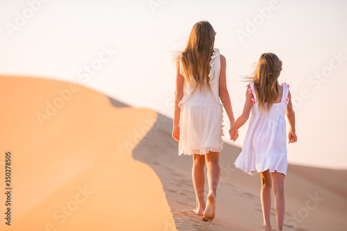 Girls among dunes in Rub al-Khali desert in United Arab Emirates © travnikovstudio