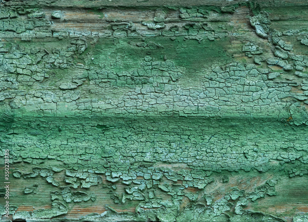 texture of old paint on a wooden surface. green paint is applied unevenly, peeling off. old rough painted surface. texture of old paint on a wooden surface. green paint is applied unevenly, peeling off. old rough painted surface.