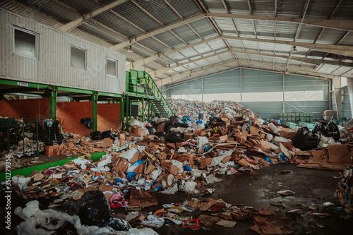 large piles of unsorted waste at the waste sorting center