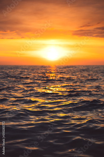 Sea sunset and ocean ripples waves as water texture background.