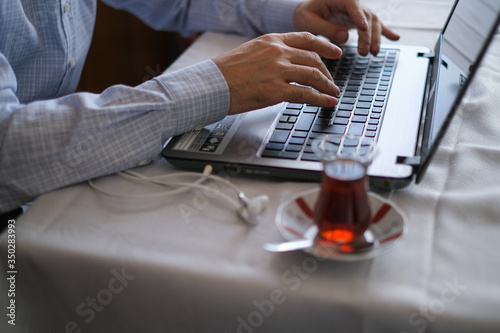 Middle-aged man is working with on laptop at home photo