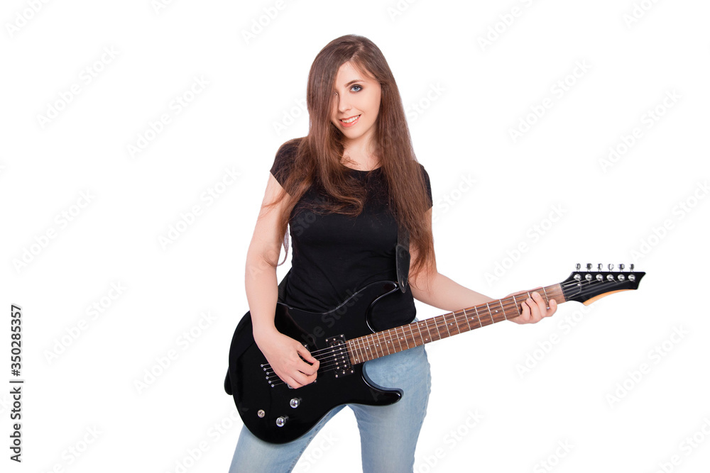 Attractive, young woman with long hair in blue jeans and a black t-shirt plays an electric guitar isolated on a white background. Attractive, young woman with long hair in blue jeans and a black t-shirt plays an electric guitar isolated on a white background.