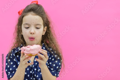 Girl going to eat a sweet donut.