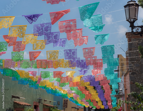  Papel picado  is a decorative craft made by cutting elaborate designs into sheets of tissue paper  common themes include birds  floral designs  and skeletons