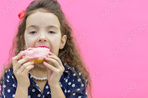 A girl standing over pink background.