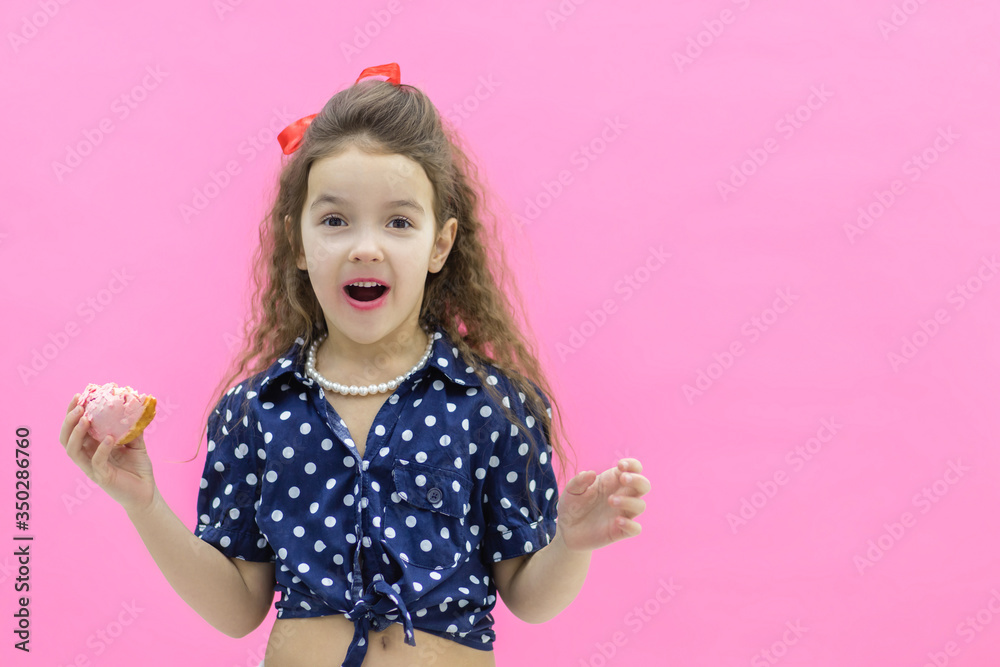 Funny smiling little girl with colorful donut on empty background. Funny smiling little girl with colorful donut on empty background.