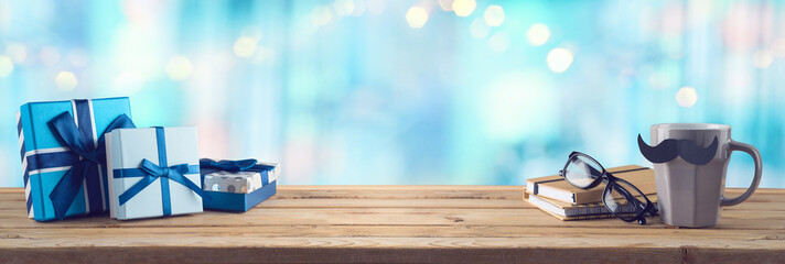 Happy Fathers day background with coffee cup, mustache and gift box on wooden table