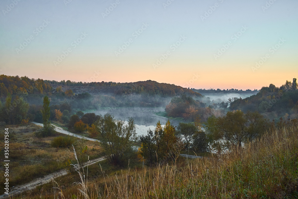 Morning river with the fog near the forest.