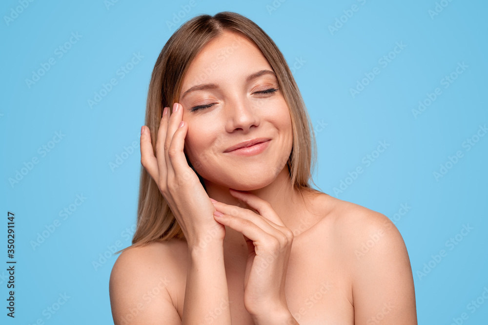 Cheerful model touching face and smiling Cheerful model touching face and smiling