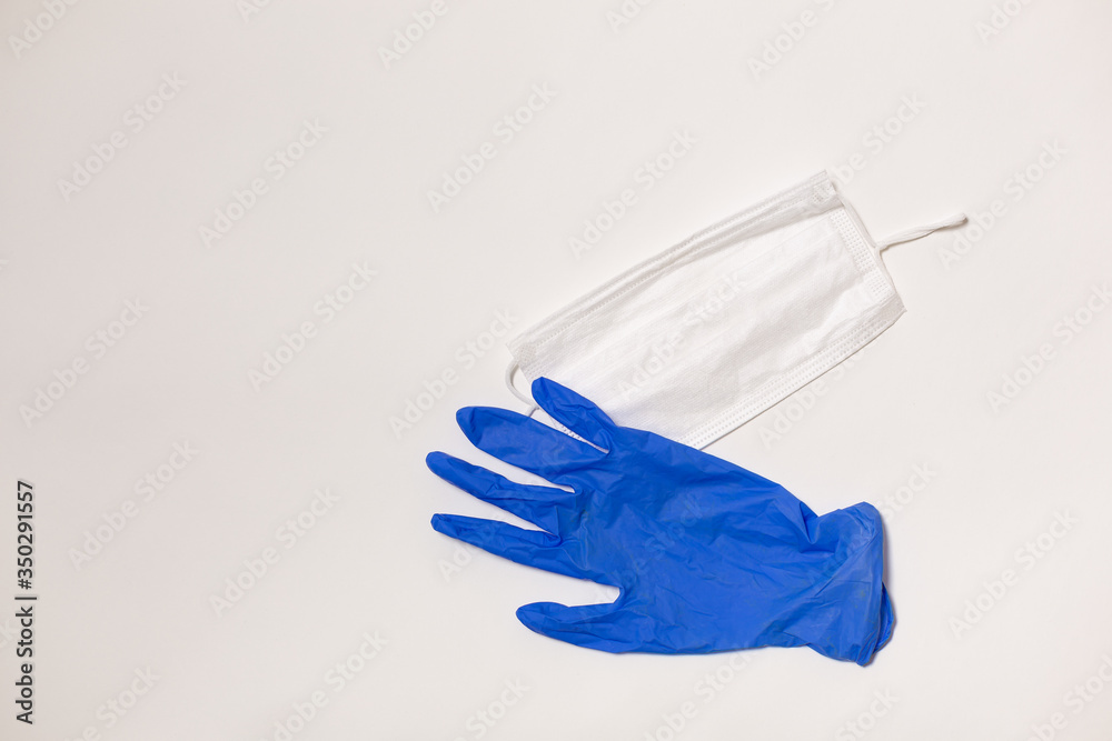 latex gloves and medical mask on white background