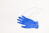 latex gloves and medical mask on white background