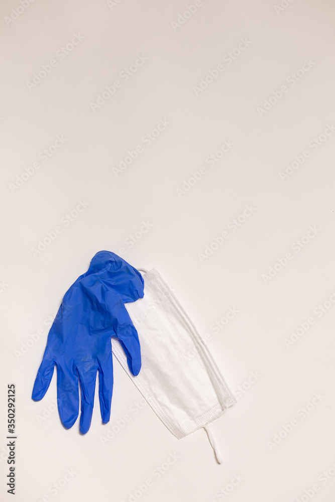 latex gloves and medical mask on white background