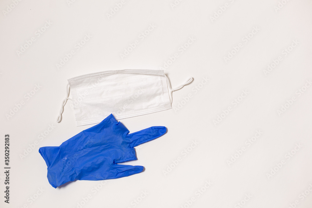 latex gloves and medical mask on white background