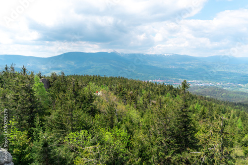 Panoramic view of the mountains and forests from the "Skalnik" summit in Poland during the spring afternoon