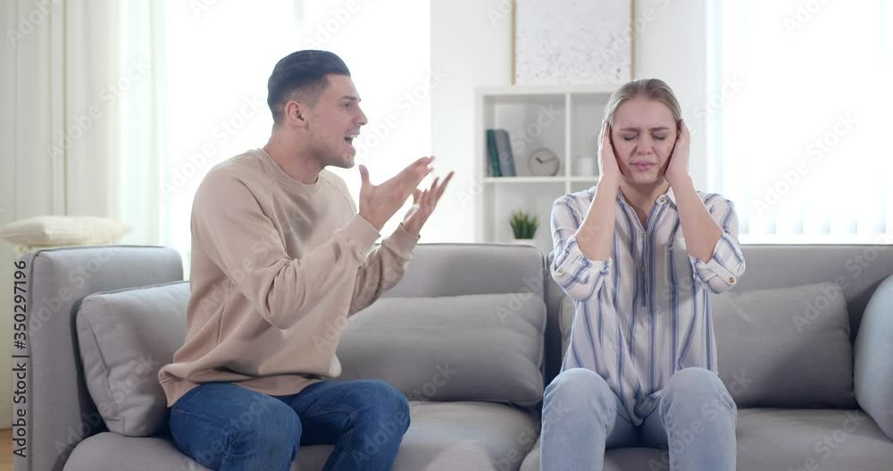 Couple having argument in living room at home. Relationship problems Couple having argument in living room at home. Relationship problems