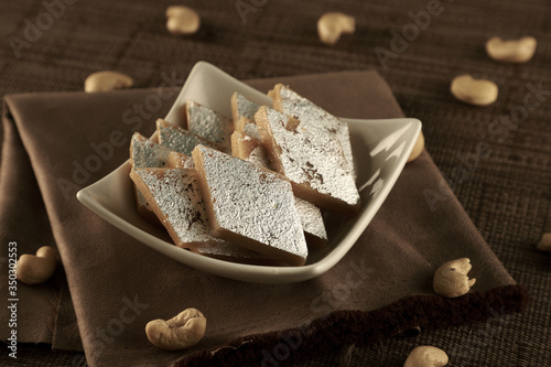 Delicious Indian Sweet Kaju Katli in a White Bowl photo