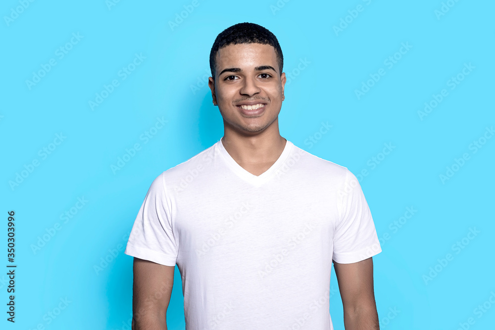Young black man smiling cheerfully, feeling happy in copy space Young black man smiling cheerfully, feeling happy in copy space