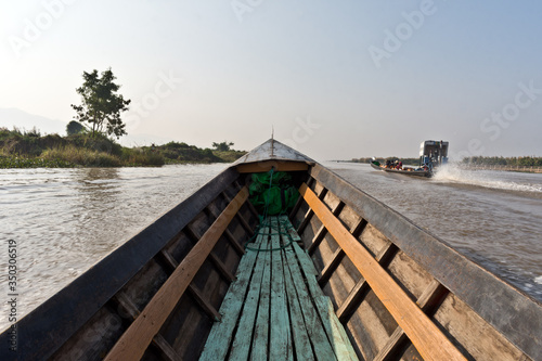 Fototapeta Naklejka Na Ścianę i Meble -  Boat going through Nampan Floating Village at Inle Lake, Nyaung Shwe, Myanmar, Asia