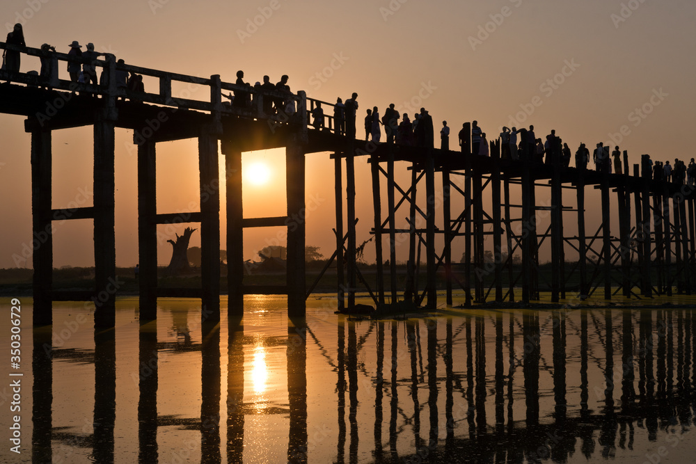 U Bein Bridge with people and sunset reflection, Amarapura, Mandalay, Myanmar, Asia