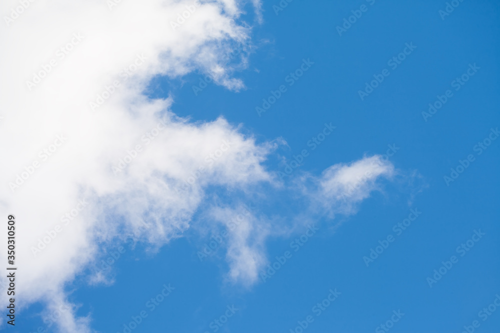 Obraz premium A white cloud is floating in the sky. Minimalist background image.