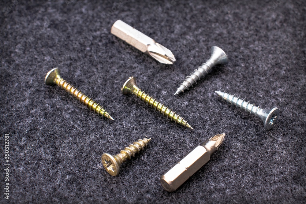 Fixing screws and bits on a black background Fixing screws and bits on a black background