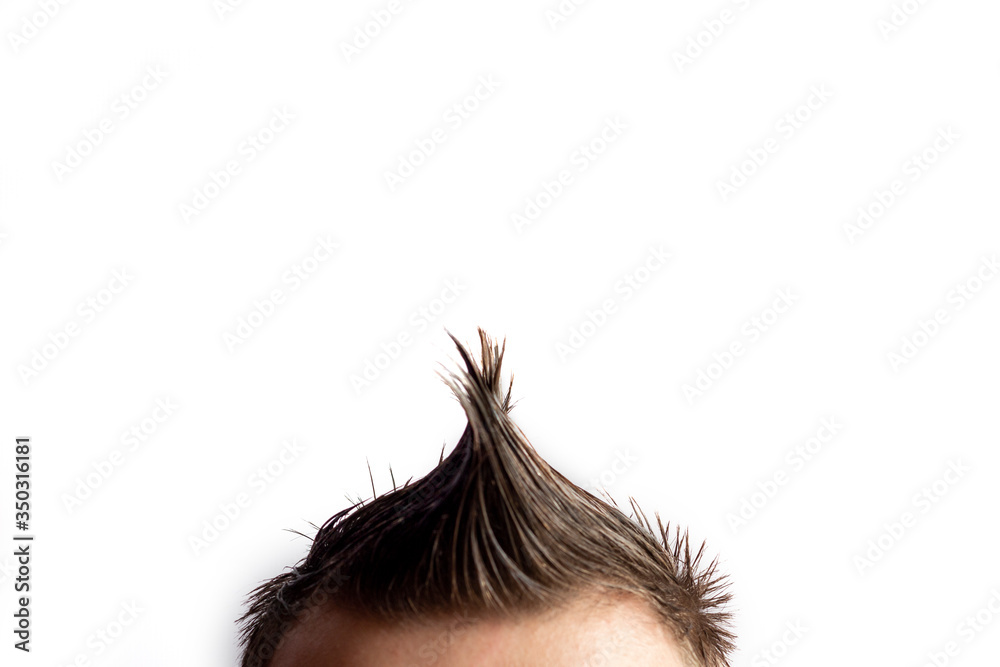 A man with a mohawk turned sideways on a white background A man with a mohawk turned sideways on a white background