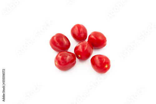 Fresh cherry tomatoes isolated on white background. Creative healthy food concept. Flat lay.