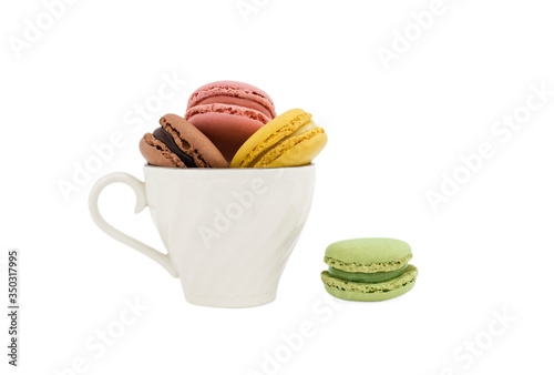 Macaroons in a cup and a green macaroon