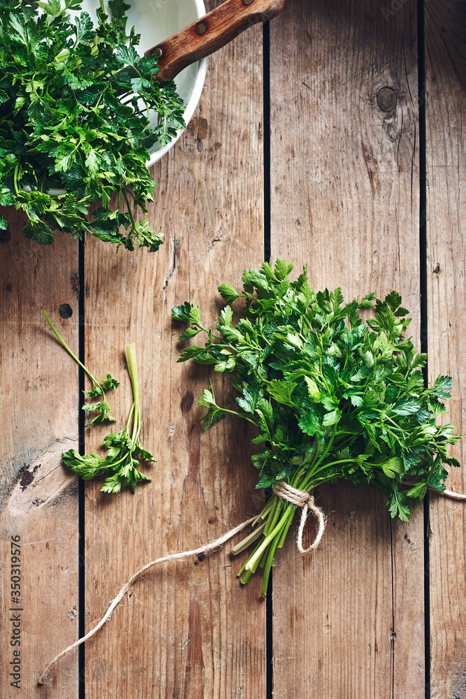 Fresh parsley on a wooden rustic background. Fresh parsley on a wooden rustic background.