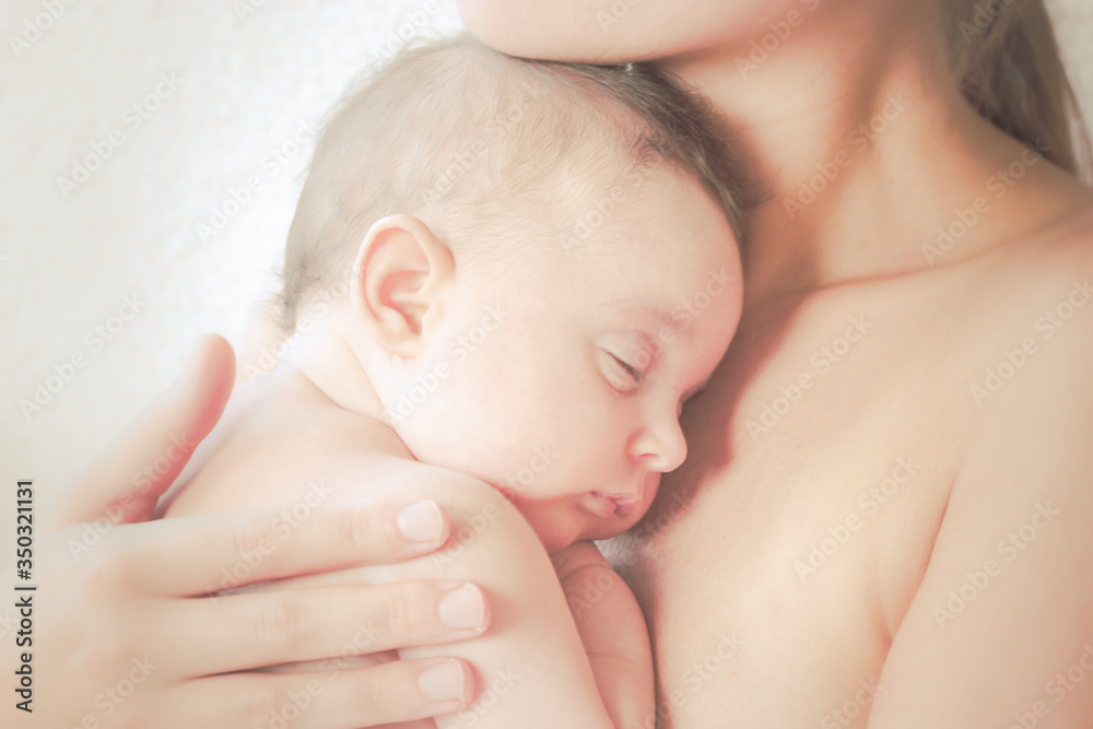 Soft-touch of a mother with her newborn Soft-touch of a mother with her newborn