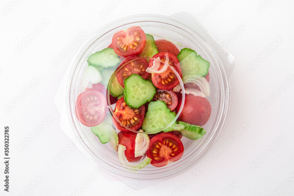 Salad in plastic package for take away or food delivery isolated on a white background. Salad in plastic package for take away or food delivery isolated on a white background.