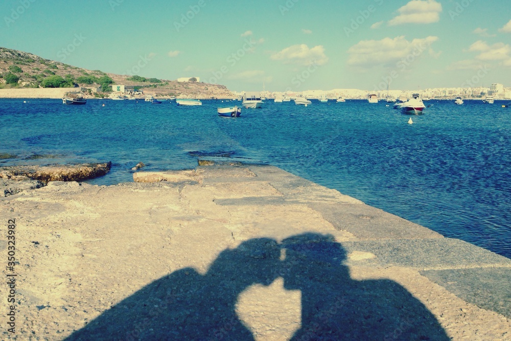 Shadow Of Man And Woman Kissing At Seaside