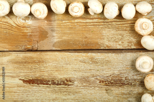 Frame of champignons on a table of rough boards.