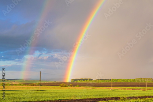 Double rainbow over the field after rain