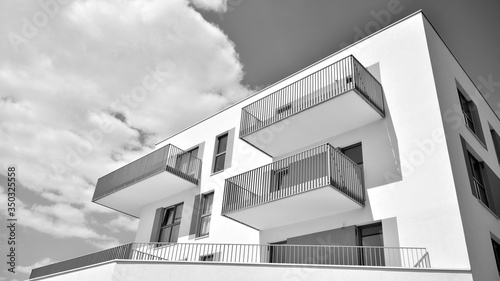 Detail of modern residential flat apartment building exterior. Fragment of new luxury house and home complex. Black and white.