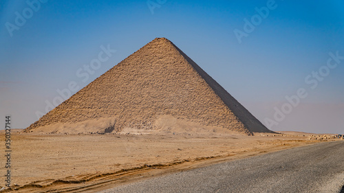 The Bent Pyramid is an ancient Egyptian pyramid located at the royal necropolis of Dahshur  approximately 40 kilometres south of Cairo  built under the Old Kingdom Pharaoh Sneferu. Egypt