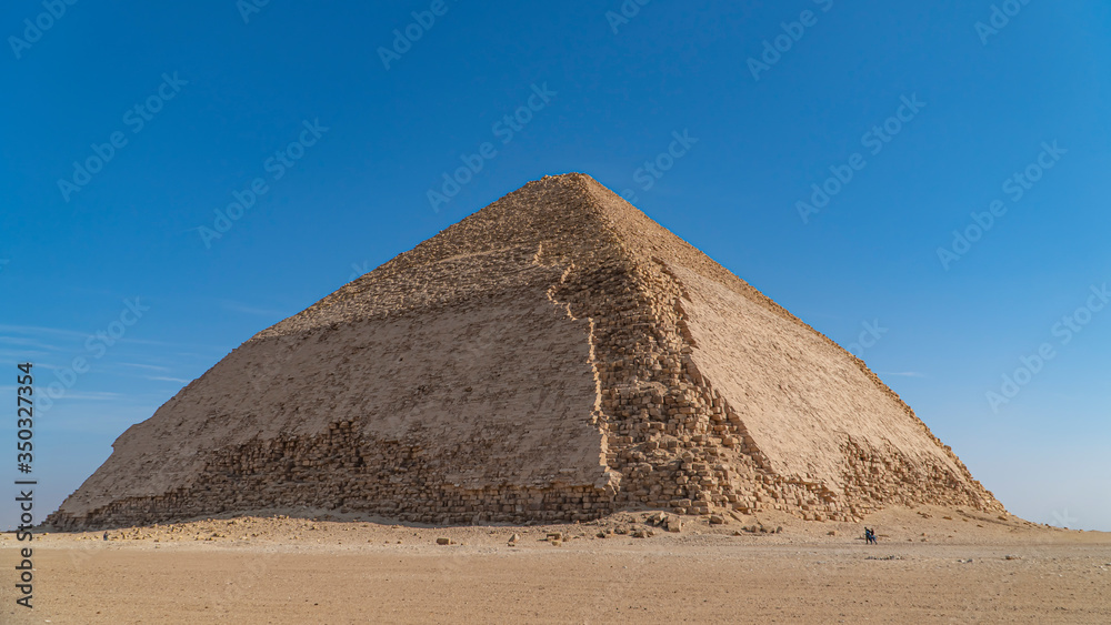 The Bent Pyramid is an ancient Egyptian pyramid located at the royal necropolis of Dahshur, approximately 40 kilometres south of Cairo, built under the Old Kingdom Pharaoh Sneferu. Egypt The Bent Pyramid is an ancient Egyptian pyramid located at the royal necropolis of Dahshur, approximately 40 kilometres south of Cairo, built under the Old Kingdom Pharaoh Sneferu. Egypt