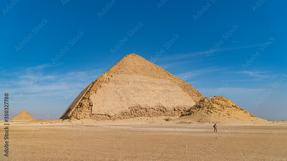 The Bent Pyramid is an ancient Egyptian pyramid located at the royal necropolis of Dahshur, approximately 40 kilometres south of Cairo, built under the Old Kingdom Pharaoh Sneferu. Egypt The Bent Pyramid is an ancient Egyptian pyramid located at the royal necropolis of Dahshur, approximately 40 kilometres south of Cairo, built under the Old Kingdom Pharaoh Sneferu. Egypt