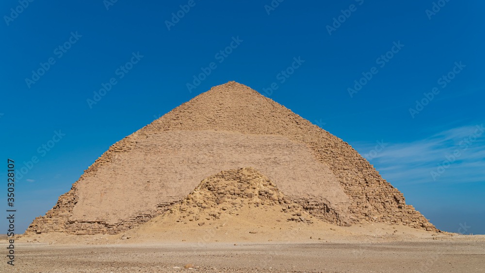 The Bent Pyramid is an ancient Egyptian pyramid located at the royal necropolis of Dahshur, approximately 40 kilometres south of Cairo, built under the Old Kingdom Pharaoh Sneferu. Egypt The Bent Pyramid is an ancient Egyptian pyramid located at the royal necropolis of Dahshur, approximately 40 kilometres south of Cairo, built under the Old Kingdom Pharaoh Sneferu. Egypt