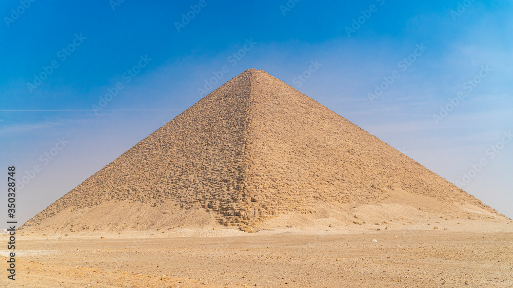 The Bent Pyramid is an ancient Egyptian pyramid located at the royal necropolis of Dahshur, approximately 40 kilometres south of Cairo, built under the Old Kingdom Pharaoh Sneferu. Egypt