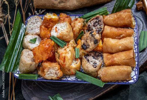 Vegetarian food : Fried taro rolls (Taro Guangjian) and Deep fried spring rolls, Fried tofu, Fried radish, Fried taro and black beans (Zhu jiao quan) on Ceramic dishes.