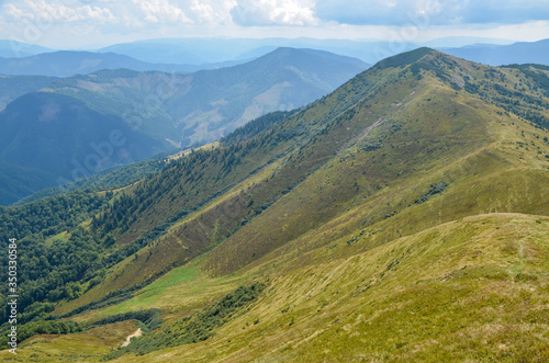 Alpine landscape with a blue sky and white clouds above the Carpathian. Mountains natural scenery of Ukraine