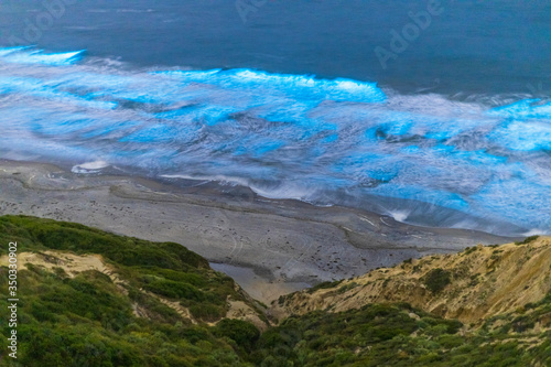 Bioluminescent red tide makes the waves glow at Black's Beach in San Diego County.