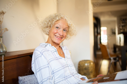happy older woman sitting at home
