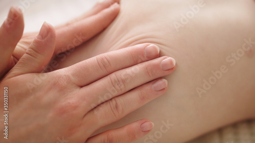 Female masseuse doing medical back massage to infant. Health care concept. Close up.
