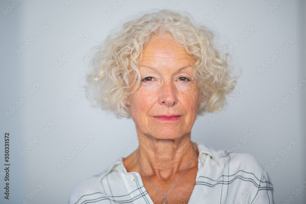 Close up beautiful older woman against white background Close up beautiful older woman against white background