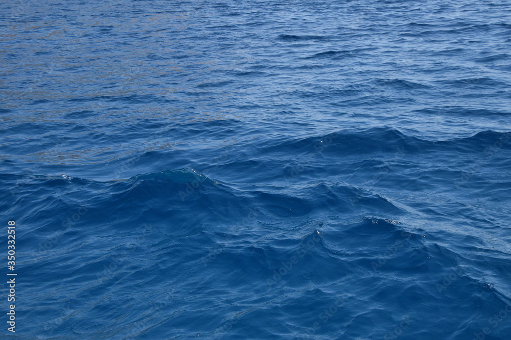 Blue sea water surface with ripples and waves Blue sea water surface with ripples and waves